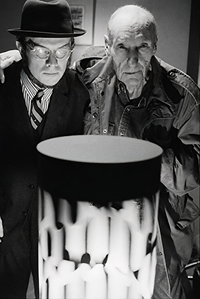 Two men examine a strange invention, once considered revolutionary, in a black and white photograph.