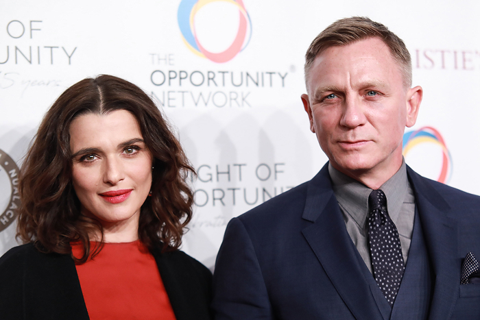 Daniel Craig and Rachel Weisz at The Opportunity Network event, smiling for the camera.
