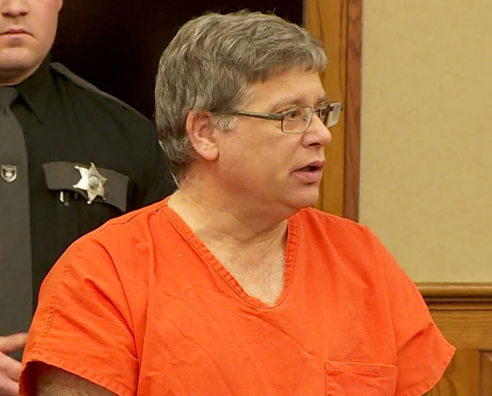 Man in orange prison jumpsuit at trial related to adopted kids case. Man in orange prison jumpsuit at trial related to adopted kids case.