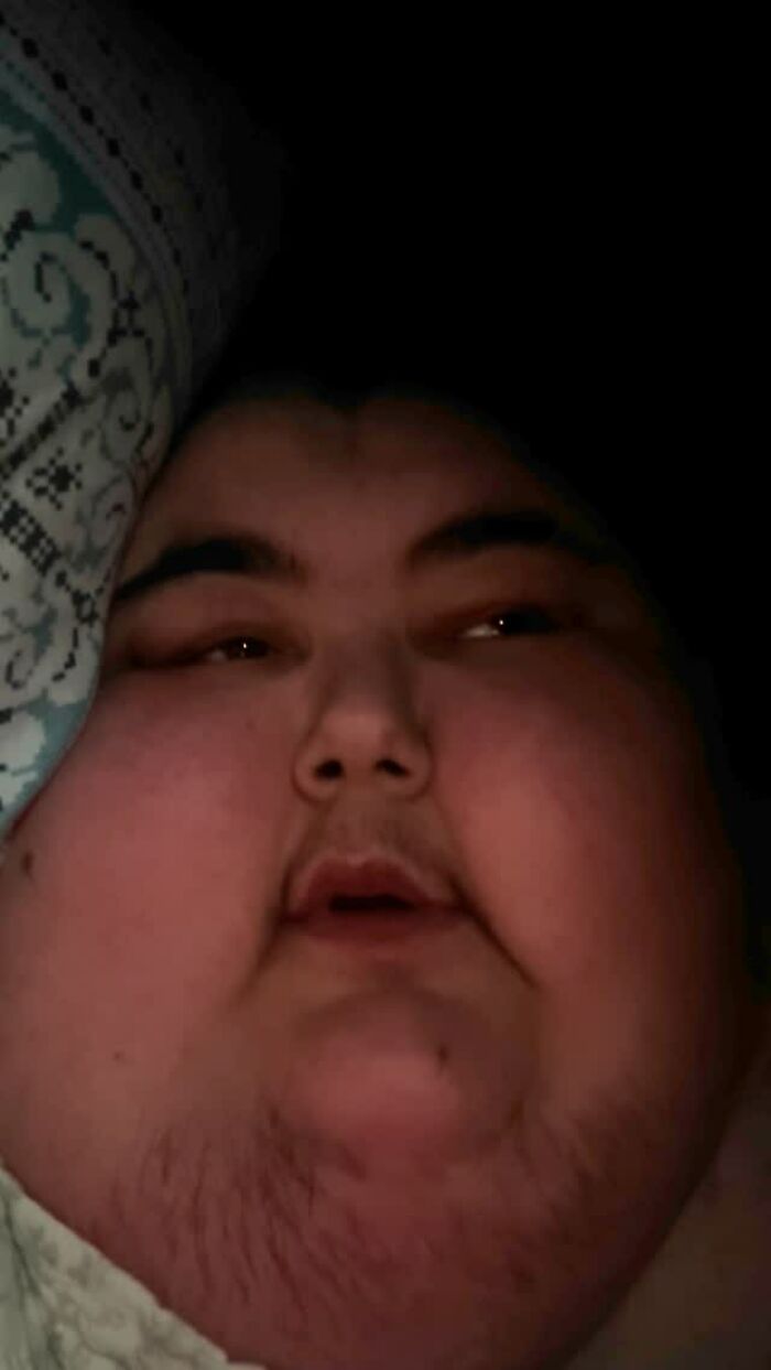 A person associated with viral mukbang videos, lying down with a pillow. A person associated with viral mukbang videos, lying down with a pillow.