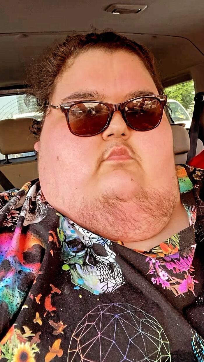 Mukbang video creator wearing sunglasses and a colorful shirt in a car. Mukbang video creator wearing sunglasses and a colorful shirt in a car.