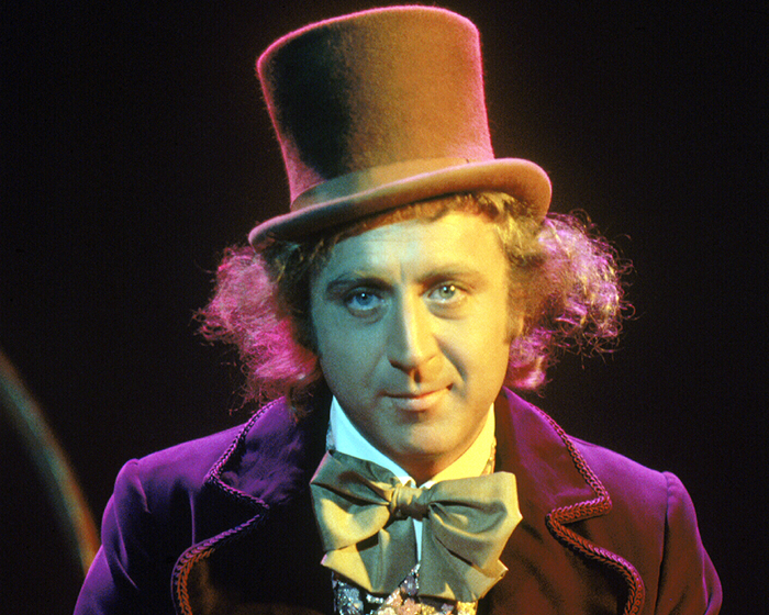 A celebrity in a top hat and bow tie, illustrating how celebrities can look more attractive in person than on screen.