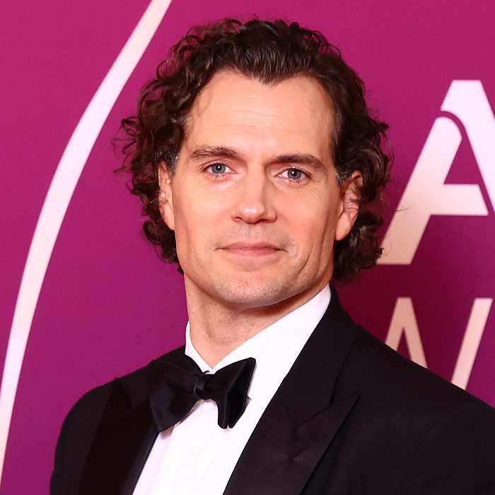 Celebrity at event in a black tuxedo, highlighting attractiveness beyond screen appearances.