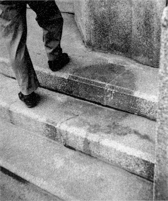 Man's legs on stone steps, hinting at a creepy history.