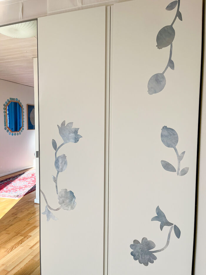 IKEA Pax Hack - A Few Flowers On The Wardrobe Doors Makes A Huge Impact. The Wall Paper Border Around The Blue Mirror Is Also From Tonka Papers