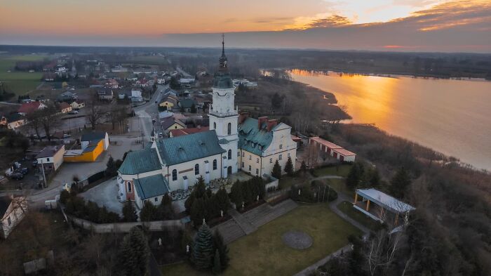 Aerial view of a city at sunset, featuring a historic church by a lake, highlighting "My City Seen From Above."