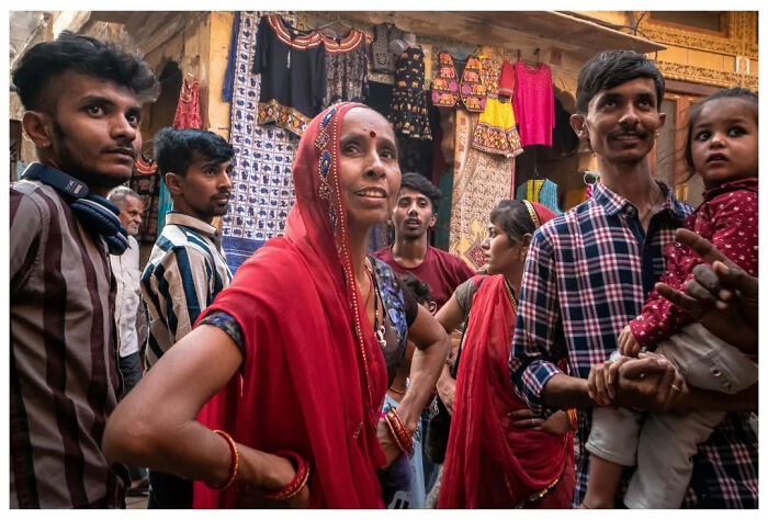 People gathered in vibrant street market scene, showcasing raw, unfiltered moments of daily life.