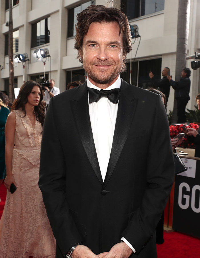 Man in a black tuxedo on the red carpet, representing successful nepo babies.