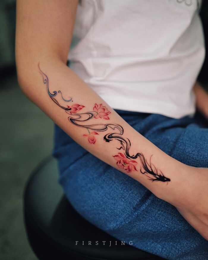 Fine-line tattoo of a koi fish with floral accents on an arm, showcasing stunning artistry in dreamy settings.