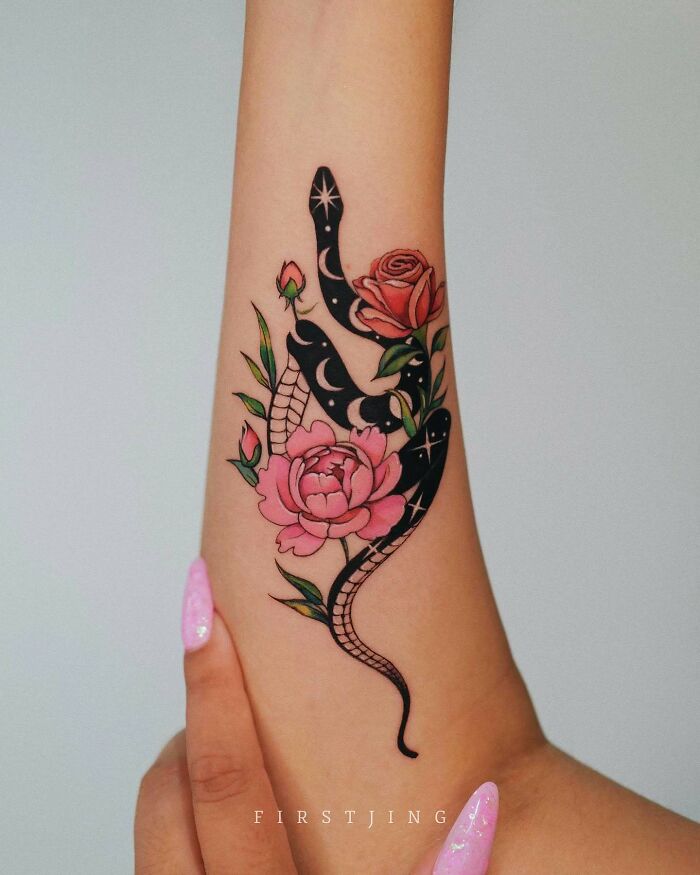 Fine-line tattoo of a black snake with pink roses, showcasing dreamy artistic design on an arm.