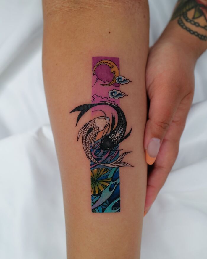 Fine-line tattoo on an arm depicting a dreamy scene with moon and fish, featuring vibrant colors.