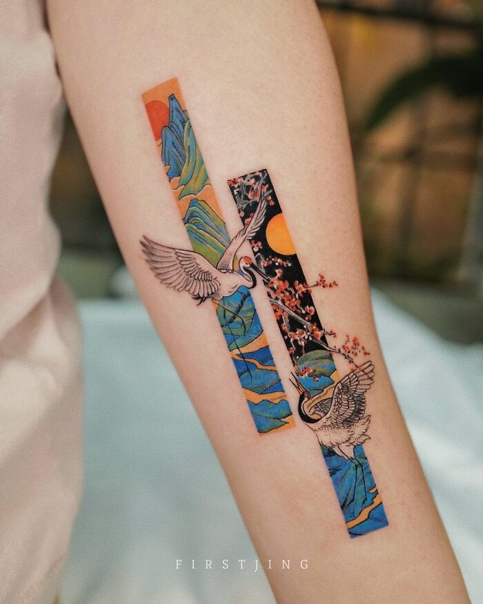 Fine-line tattoo featuring cranes and cherry blossoms in dreamy, colorful settings on a forearm.