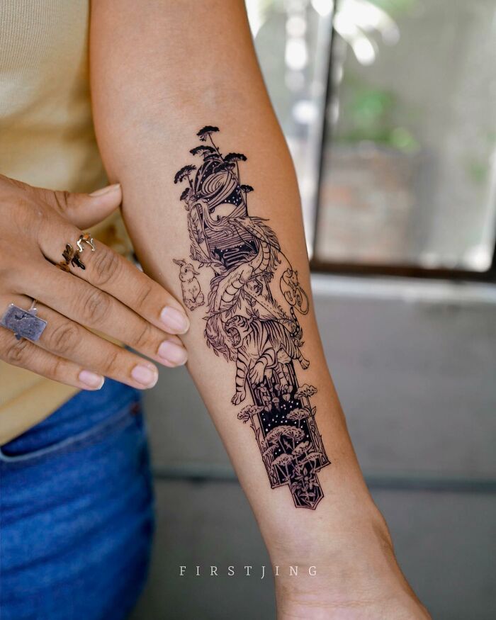 Fine-line tattoo with dreamy scenery on forearm, featuring intricate designs of a tiger and nature elements.