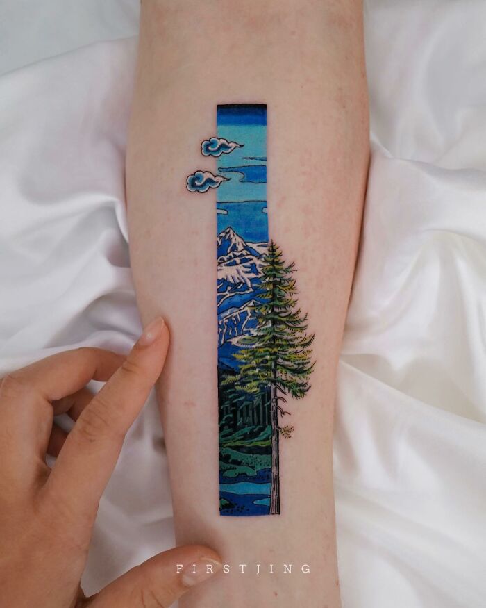 Fine-line tattoo featuring a dreamy landscape with mountains and trees.