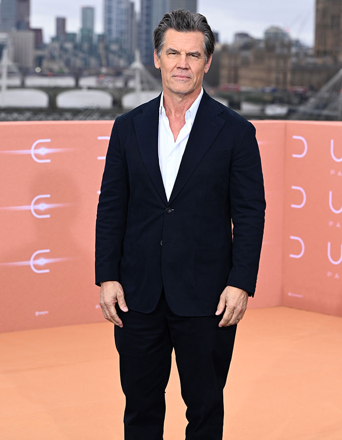 Man in a black suit at an event, showcasing talented nepo babies theme.