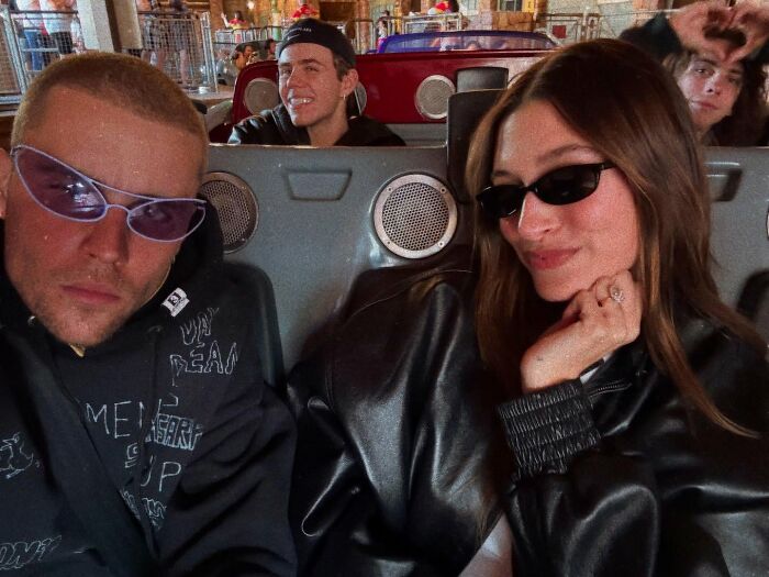 Young couple in sunglasses on a ride, raising concerns about Justin Bieber&rsquo;s health with recent cryptic posts.