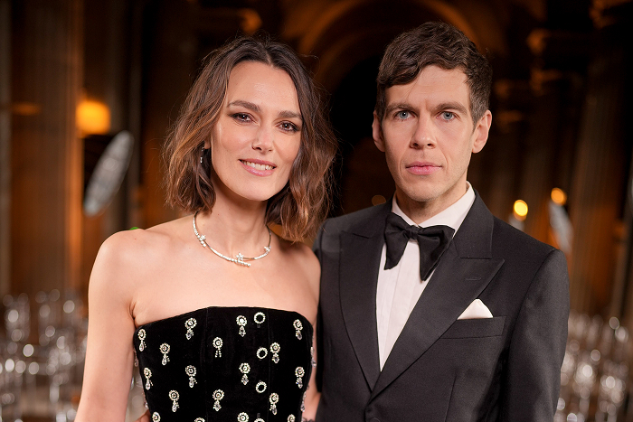 Keira Knightley and James Righton posing together in formal attire at an elegant event.