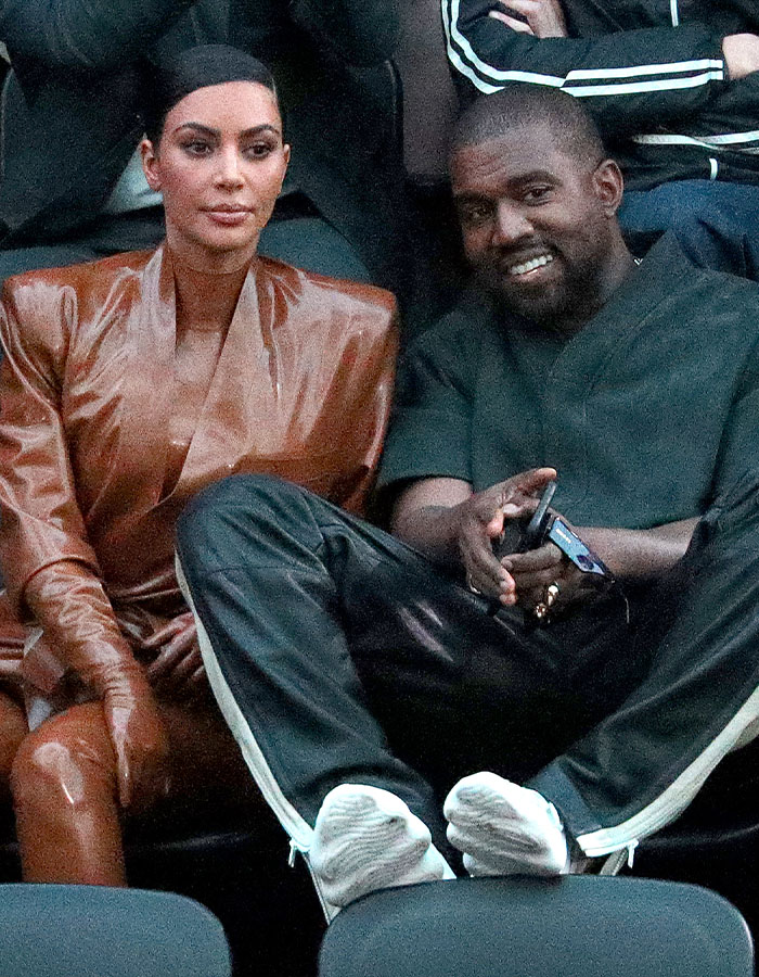 Kim and Kanye seated together at an event, generating attention related to their family dynamics and music involvement. Kim and Kanye seated together at an event, generating attention related to their family dynamics and music involvement.