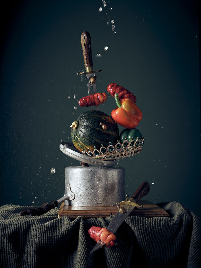 Still life composition with vegetables, a crown, and knives, showcasing stunning photography creativity from the 2024 IPA.