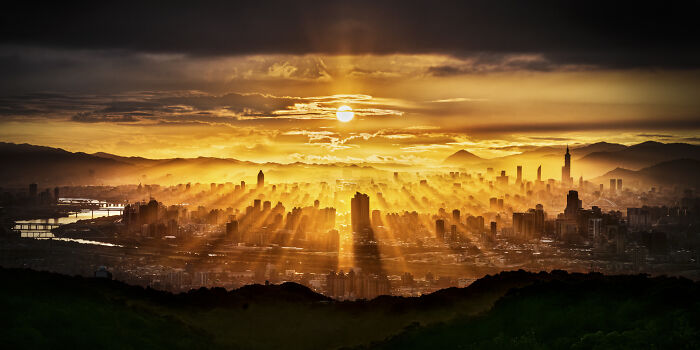 Golden sunrise over a city skyline, showcasing stunning photography from the 2024 IPA winners and finalists.