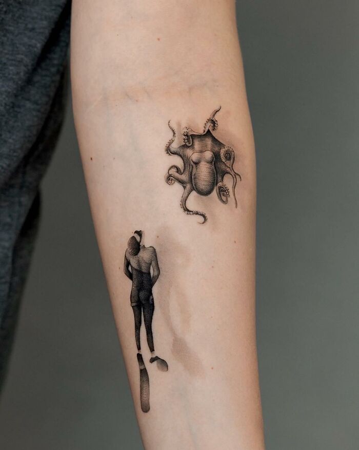 Lifelike tattoo by Tatu Panda featuring an octopus and a person on an arm.