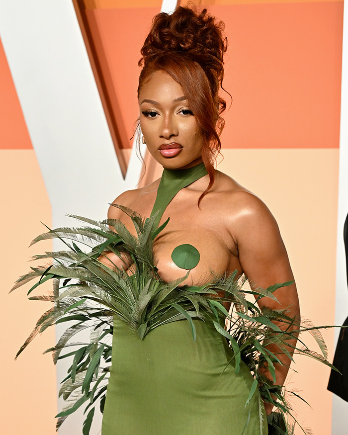 A celebrity wearing a revealing green dress on the red carpet, sparking fury in 2025.