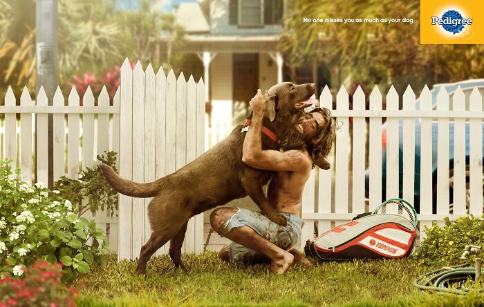 Man hugging dog in front yard, campaign showcasing unforgettable canine bonds worldwide.