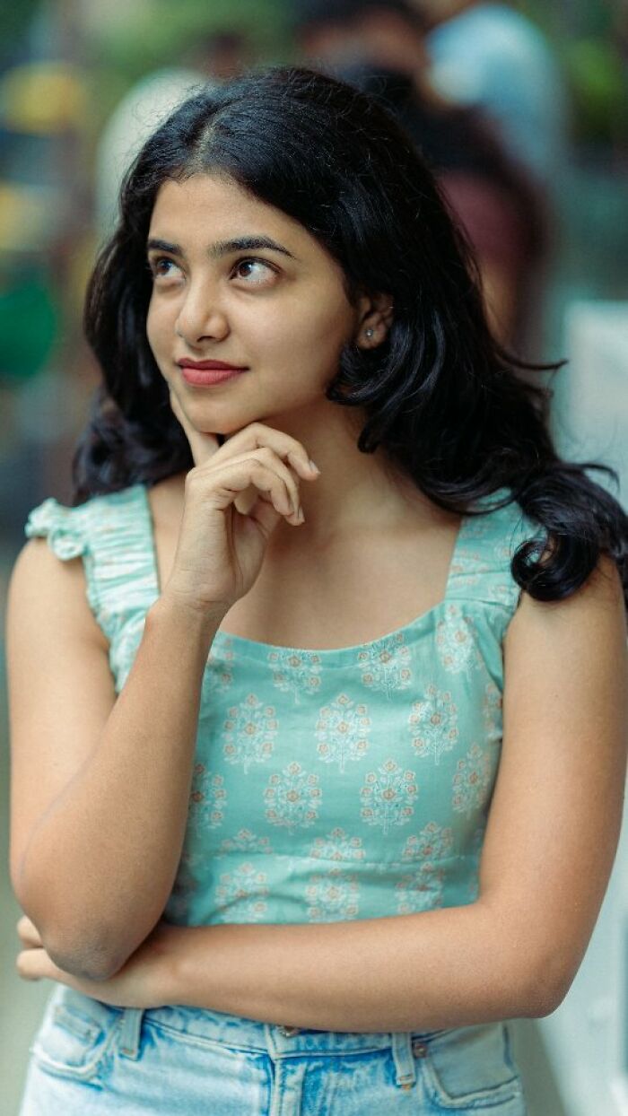 Portrait of a woman in a patterned green top, showcasing beauty captured by an Indian photographer.