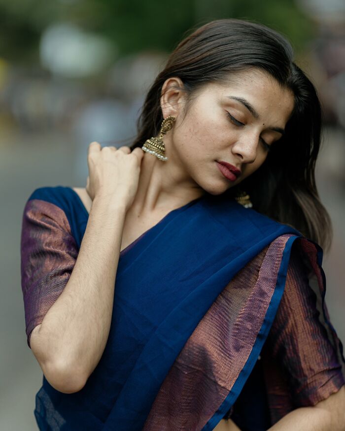 Portrait of a woman in a blue sari, showcasing the beauty captured by an Indian photographer.