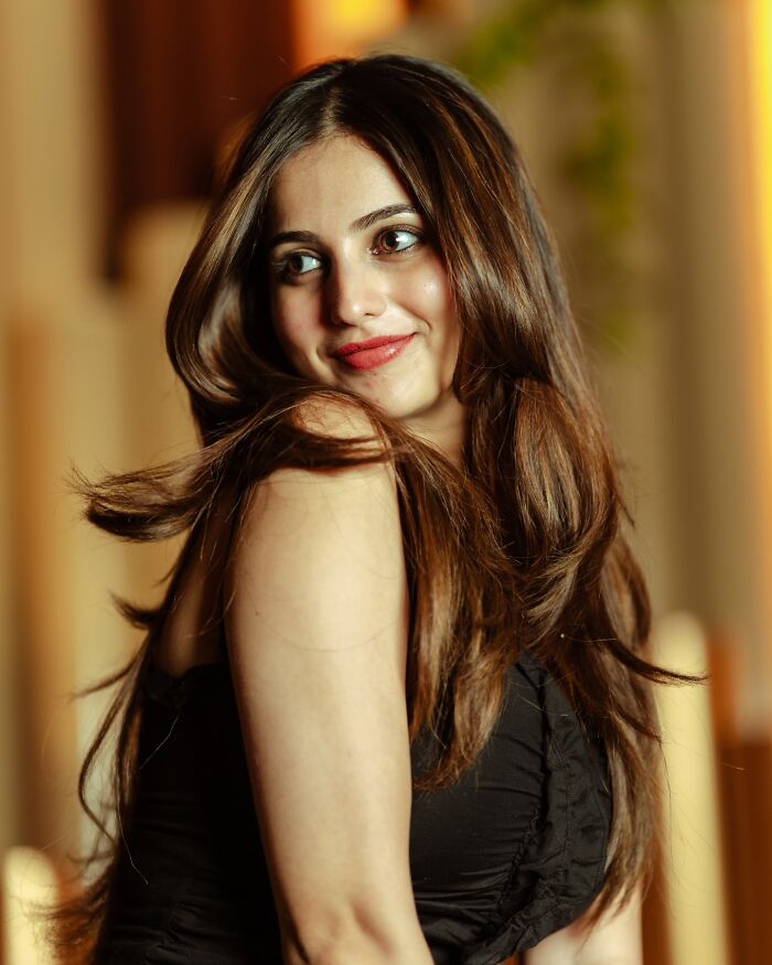 Portrait of a woman with flowing hair, captured by an Indian photographer revealing beauty in strangers.
