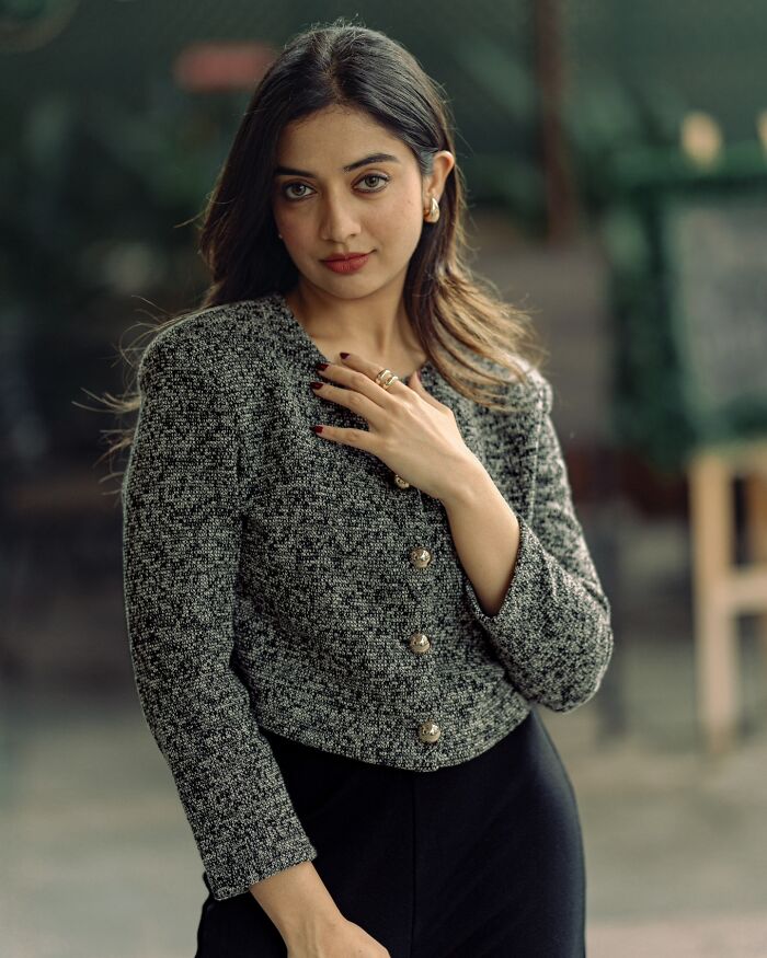 Portrait of a woman in a textured jacket, captured beautifully by an Indian photographer.