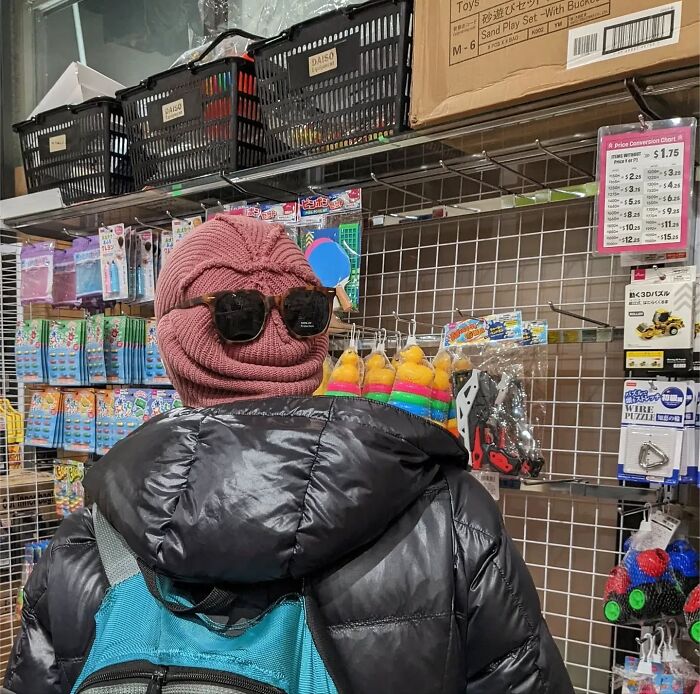 Person in a store with a pink knit hat and sunglasses, capturing San Francisco's essence through unique fashion.