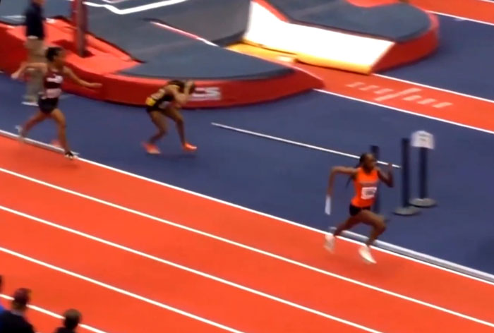 Track star running with baton during race incident.