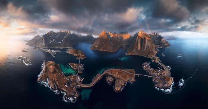 Aerial view of stunning landscapes with dramatic skies and rugged mountains surrounded by ocean.