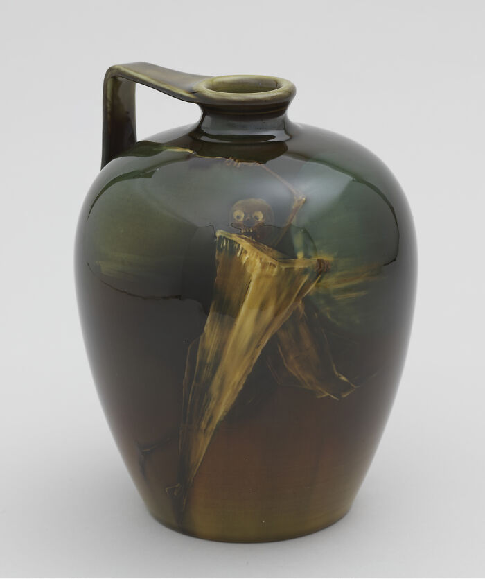 Unsettling past photo: eerie jug with a painted skeleton emerging, creating a haunting effect.