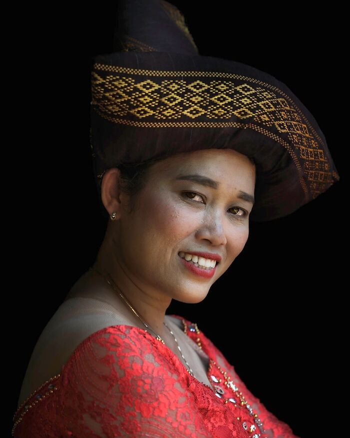 Woman in traditional attire with ornate headpiece, showcasing cultural beauty from around the world.