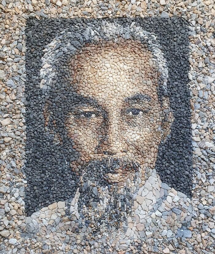 Portrait mosaic made from stones and pebbles by a British artist, showcasing intricate detail and artistry.
