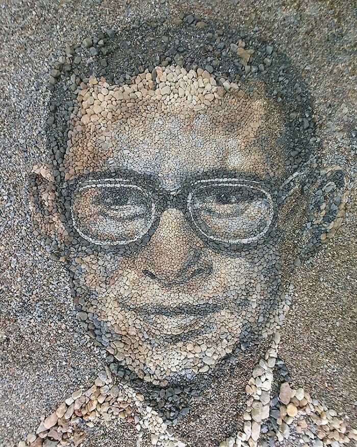 Intricate mosaic portrait made from stones and pebbles by British artist.