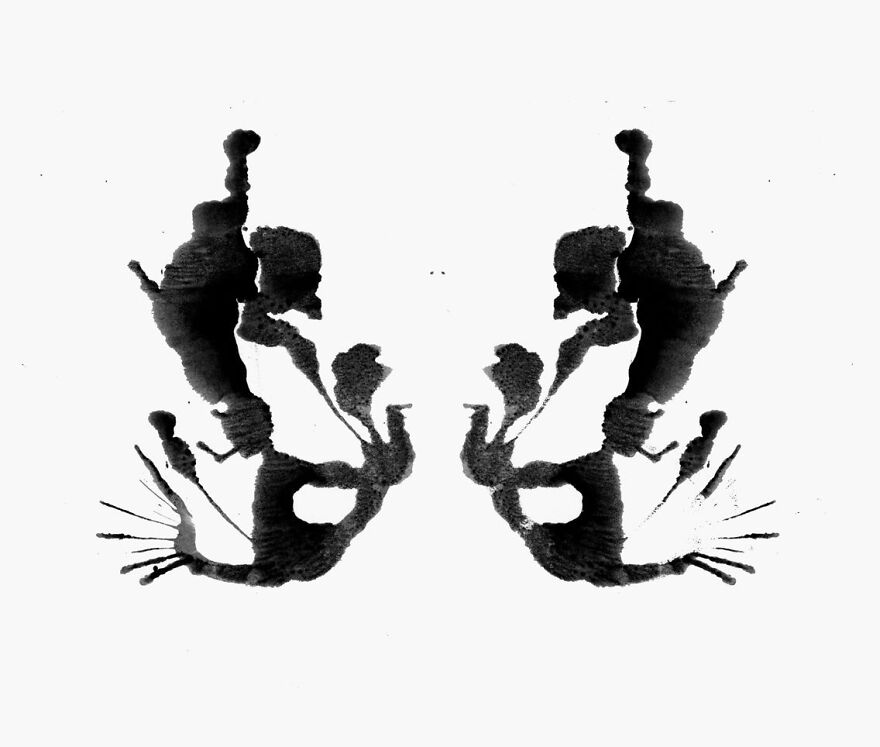 Rorschach inkblot resembling abstract shapes against a white background.