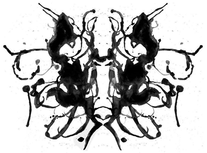 Rorschach inkblot image with symmetrical black patterns on a white background.