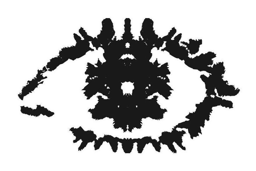Rorschach inkblot resembling an eye, inviting viewers to compare their perception with the majority.