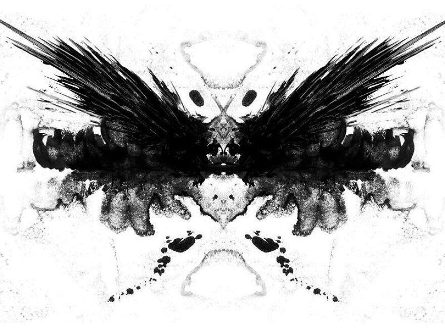 Rorschach inkblot test with symmetrical black patterns on white background.