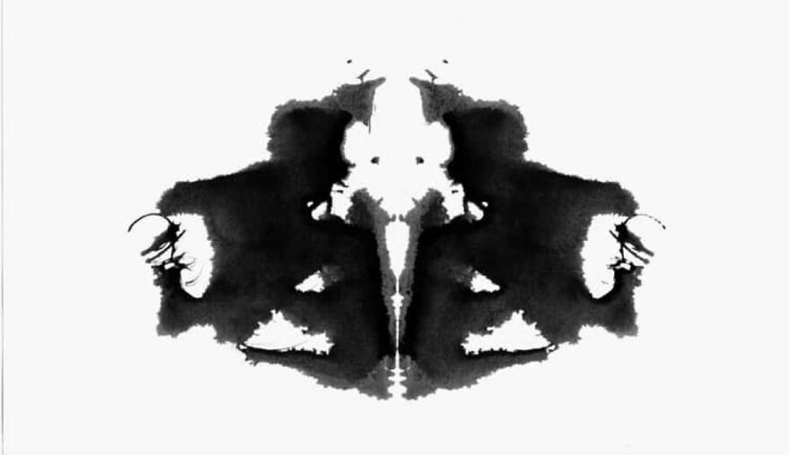 Rorschach inkblot test image inviting viewer interpretation in a psychological survey context.