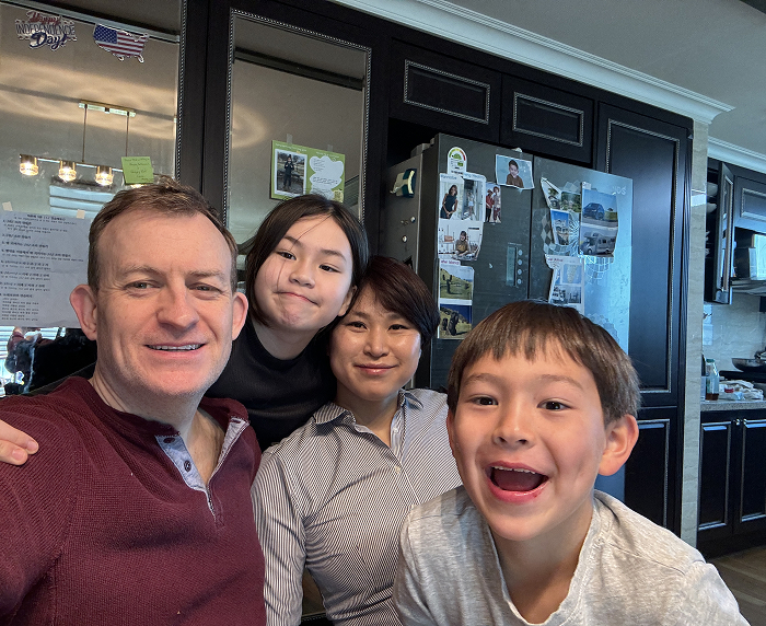 Family of "BBC Dad" with children grown up, smiling in the kitchen. Family of "BBC Dad" with children grown up, smiling in the kitchen.