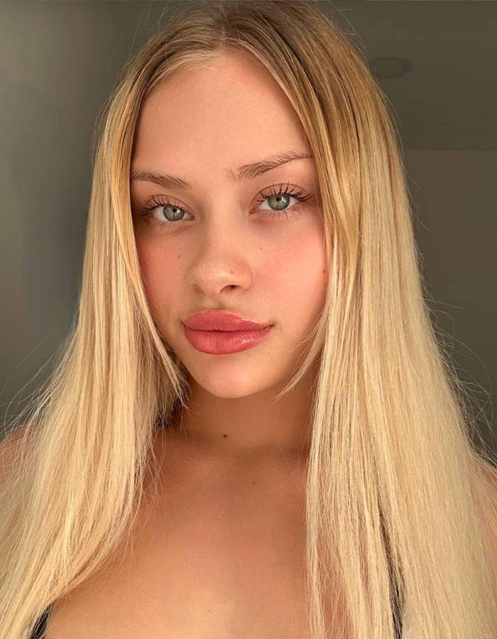 Blonde woman possibly involved in model trafficking investigation at controversial parties.