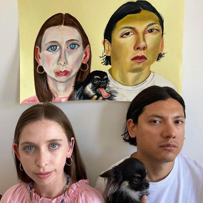 Couple with dog posing under expressive portraits by a British artist, highlighting unique artistic style.