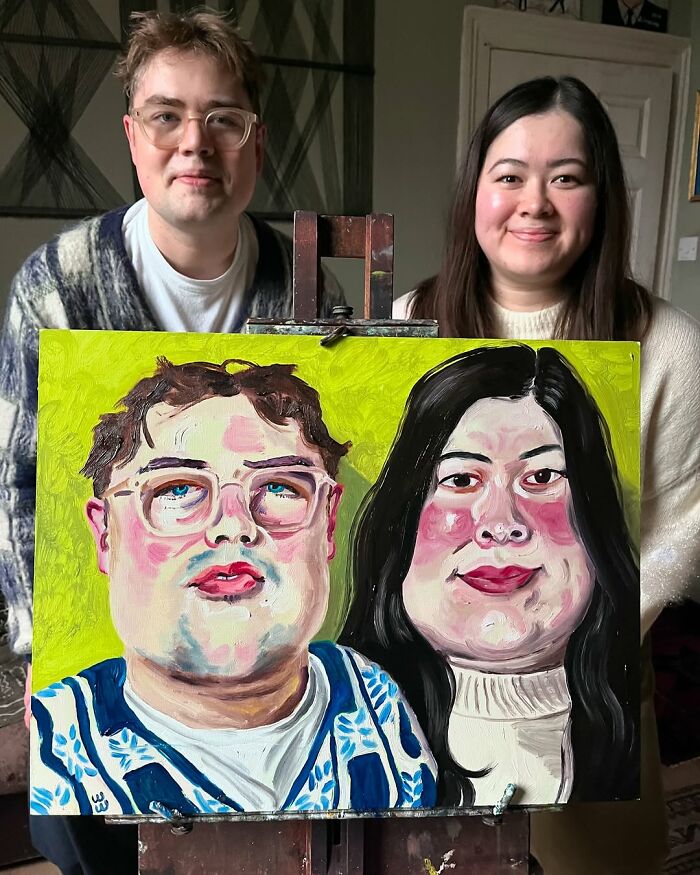 British artist displays expressive portraits on easel, featuring vibrant painting of two smiling individuals.