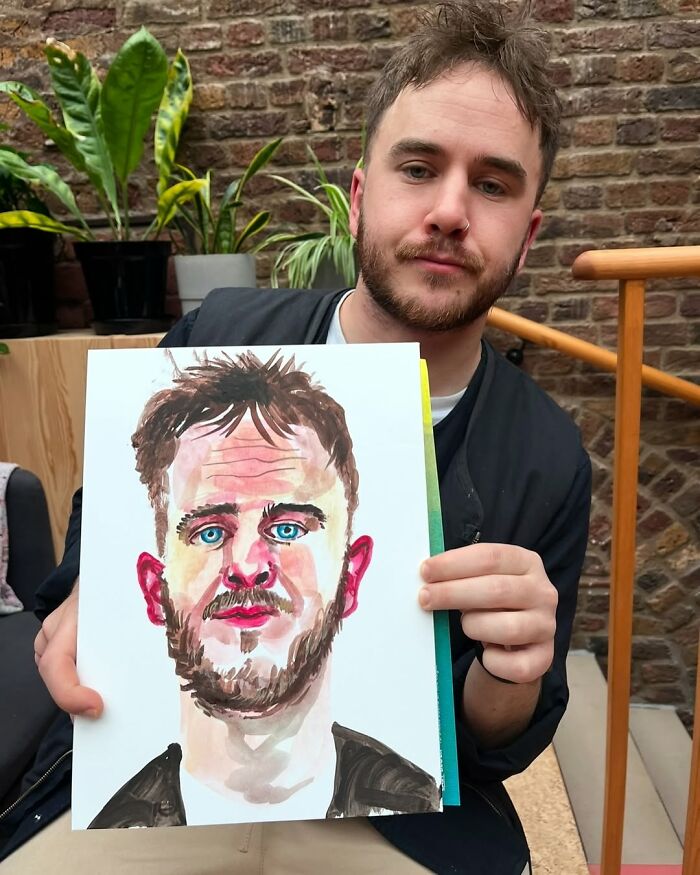British artist displaying his expressive portrait artwork, featuring vivid colors and dynamic expression.