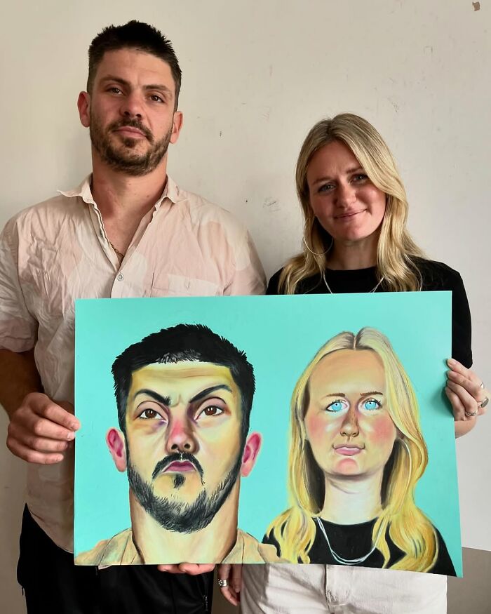 British artist holding expressive portrait painting with a woman, showcasing unique artistic style against a plain backdrop.