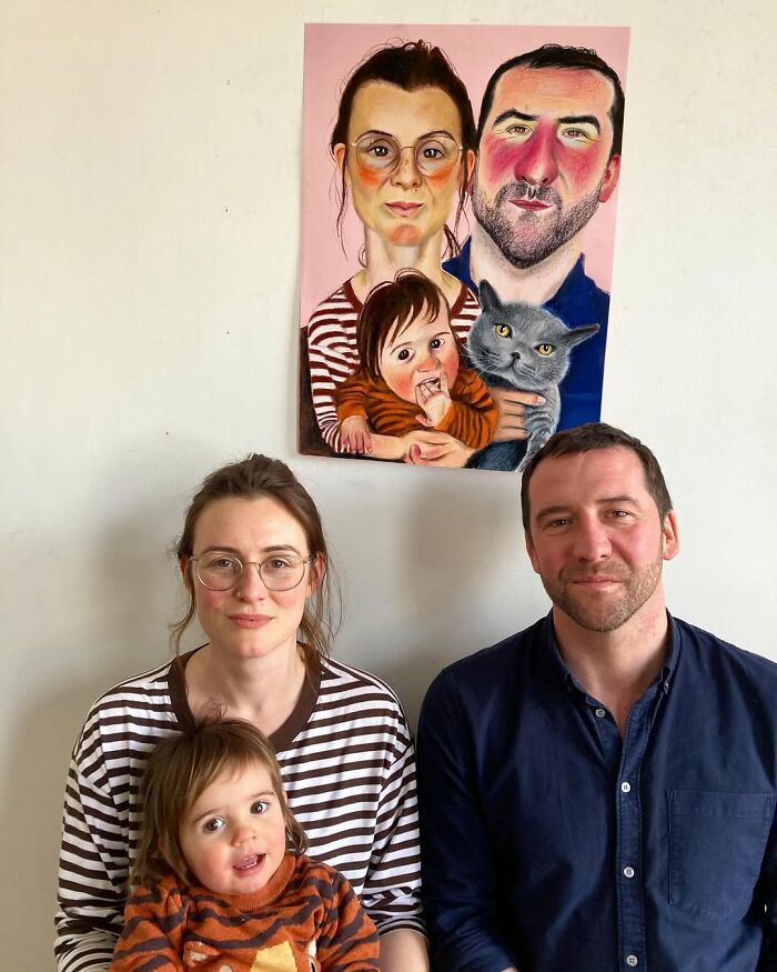 Family beneath an expressive portrait showcasing a British artist's unique style.
